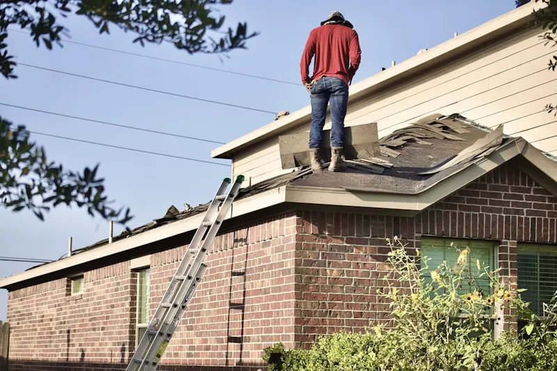 Professional roofer working on a residential roof in Layton
